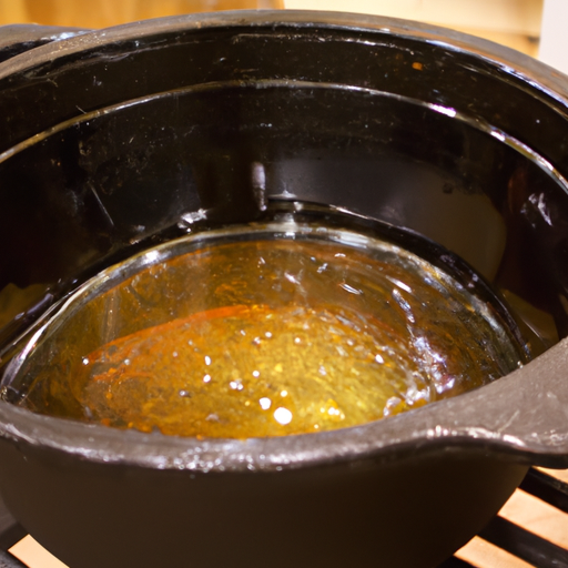 A Dutch oven being seasoned with a thin layer of oil.